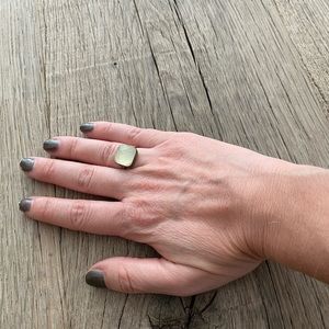Gold ring with pale green gemstone